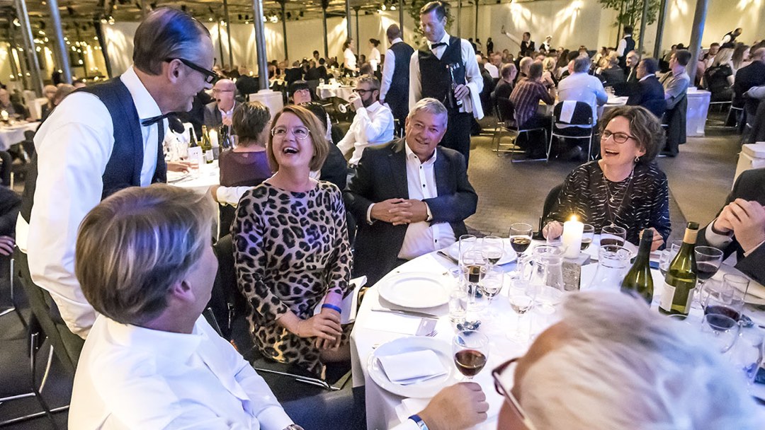 Waiter making guests laugh