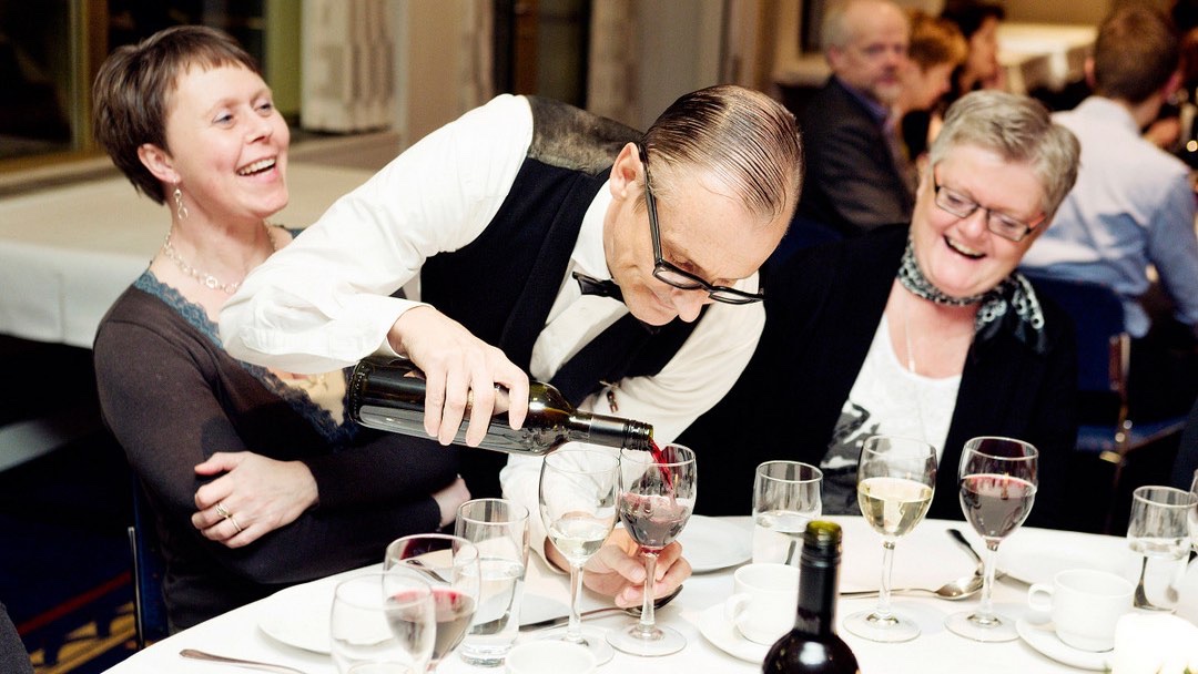 waiter pours wine