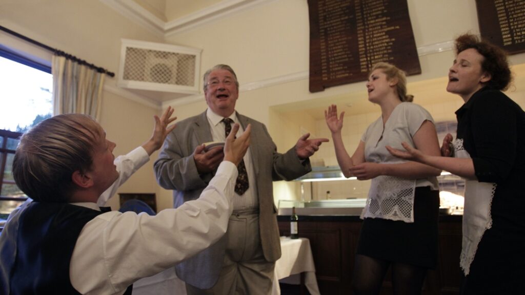 waiters sing for the birthday child