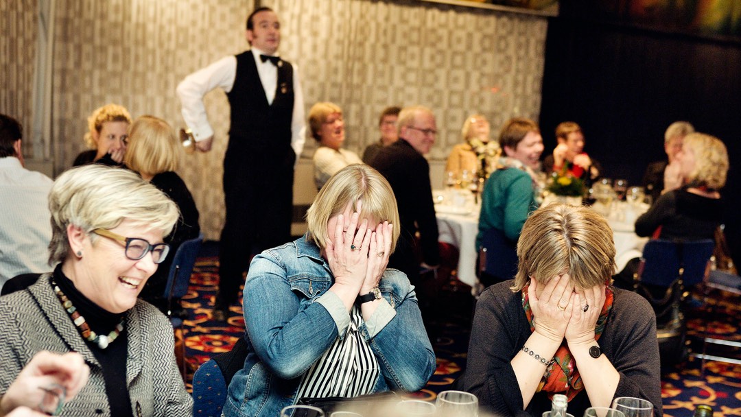 Waiter with laughing women