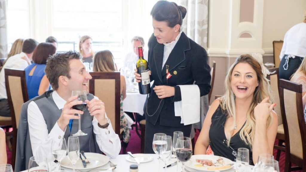 waiter and happy guests